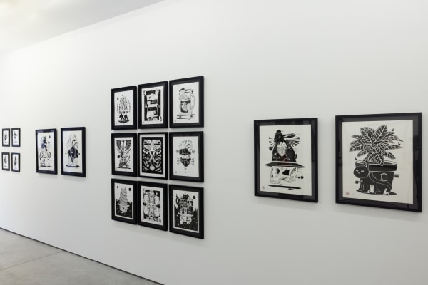 black and white illustrations by artist Jeremy Fish on a white wall