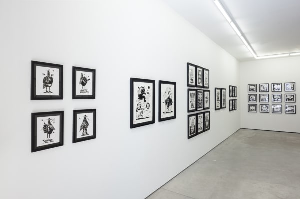 black and white illustrations by artist Jeremy Fish on a white wall