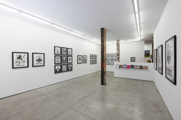 black and white illustrations by artist Jeremy Fish on a white wall
