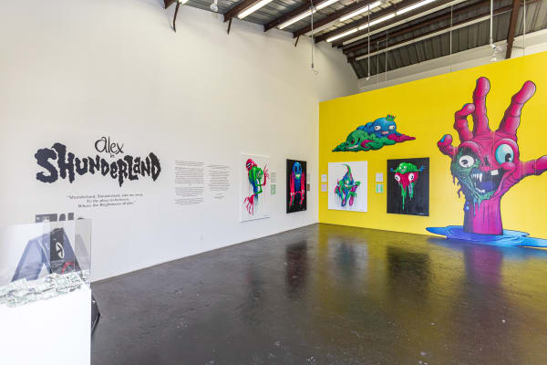 Install photo of brightly colored Alex Pardee exhibition
