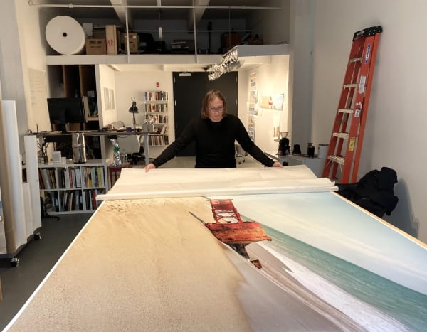 MICHAEL'S FRIEND AND FORMER ASSISTANT, ANTHONY, INSPECTING A PRINT ON ITS WAY TO THE MOUNTER