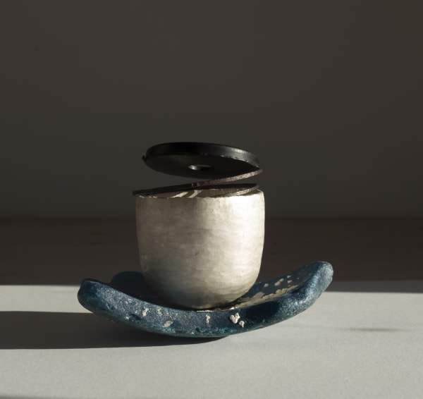 Sprung Vessel Silver, stainless steel, found plastic lid, found buoy fragment 9cm high, 11cm long Stuart Cairns