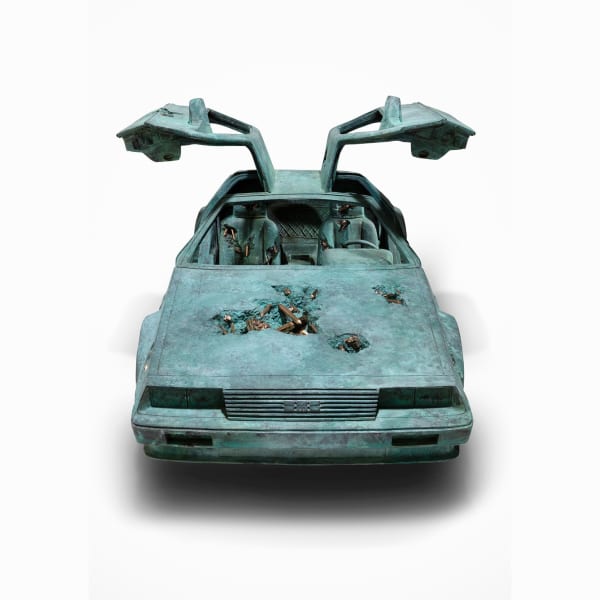 Daniel Arsham, Bronze Eroded Delorean 1:2, 2022. Bronze, stainless steel, patina, 38 x 72 x 30 3/4 in (96.5 x 182.9 x 78.1 cm). Courtesy of the artist and Perrotin