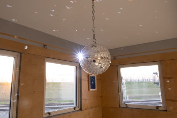 An installation image from the exhibition DANCER by Leah Shirley at Sibyl Gallery. The image features a custom disco ball with small mirrors cut into butterfly shapes.