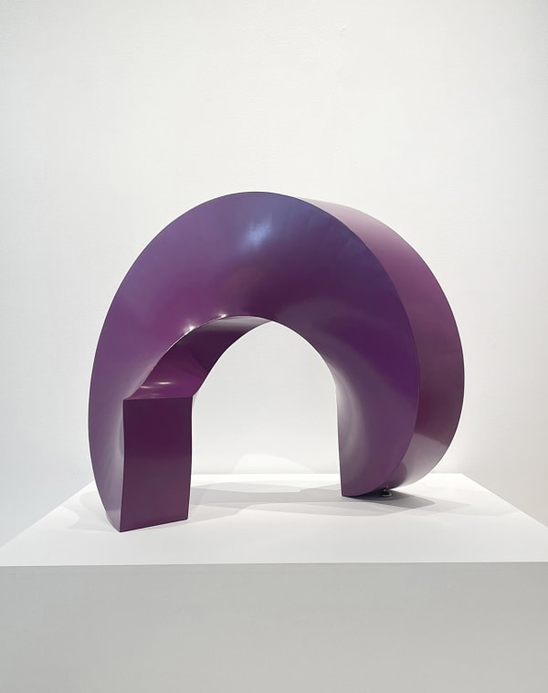 Round abstract sculpture that sits on a square base