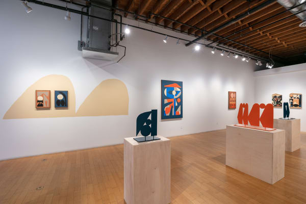 Installation view of the left and back walls of the gallery facing from the door with sculptures on plywood pedestals in the middle.