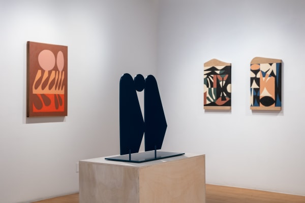 Installation shot showing the back left corner of the gallery. Much Closer To The Source sits on a plywood pedestal. To the left is All In a Completely Non-Destructive Environment and to the right is Consciously Leave the Body and A Lens Into Human Nature