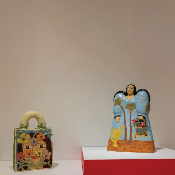 Maryam Yousif Object left: Cosmic Handbag: Seeing Through Wild Flowers, 2022 Object right: Fashion Show Model in Landscape Dress, 2021 Courtesy of the artist and the Museum of Arts and Design. Photography by Jenna Bascom.