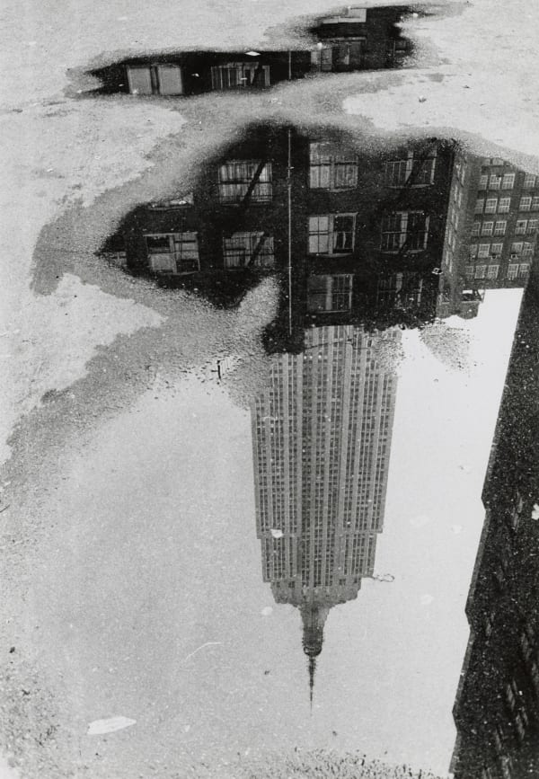 André Kertész (1894-1985) Puddle, Empire State Building, 1967 Gelatin silver print, printed c. 1970s Estate stamp on verso 10 x 8 in (25.4 x 20.3 cm)