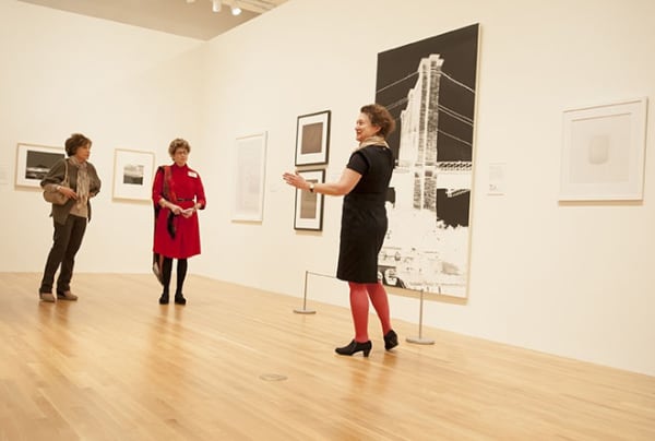 Guest curator Patricia Leighten, Professor of Art History & Visual Studies at Duke (right), who co-organized Light Sensitive with Nasher Museum Director Sarah Schroth, leads a tour of the exhibition. Photo by J Caldwell.