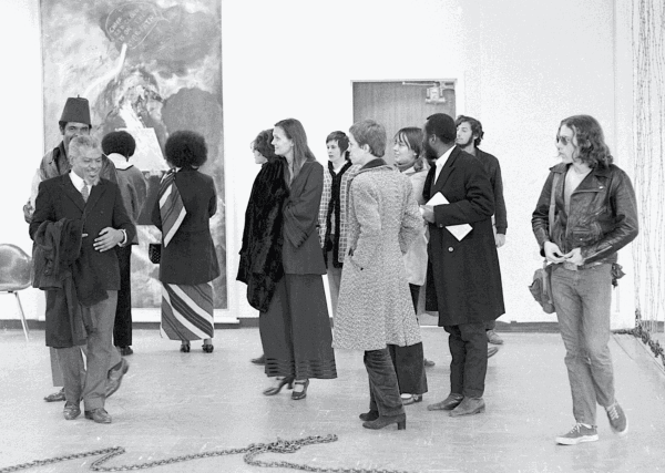 5+1 exhibition opening at Stony Brook University, 1969, with attendees Bill Rivers (left front), Melvin Edwards (left, behind Rivers), Jayne Cortez (middle, back to camera), and Frank Bowling (second from right), among others, photographed by Adger Cowans (© Adger Cowans; Courtesy Bruce Silverstein Gallery, New York, NY)