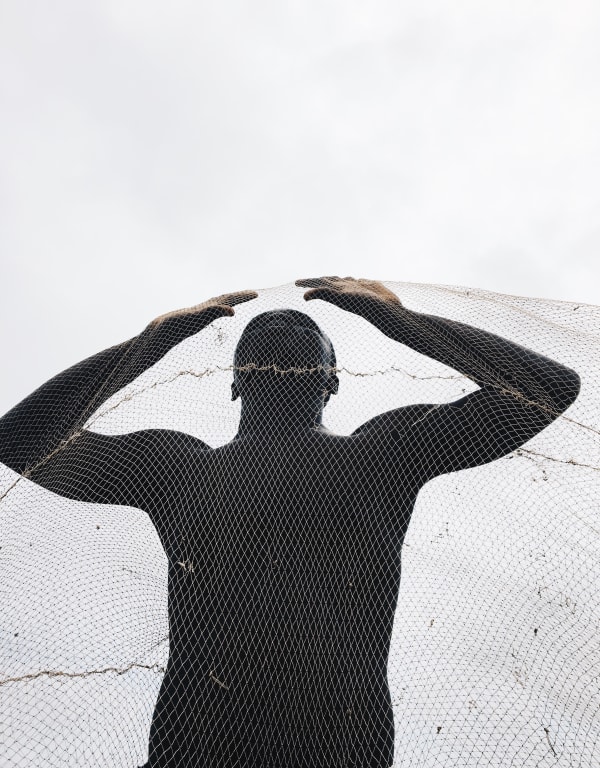 Photograph by Ghanaian Nana Yaw Oduro presenting a behind a fishnet