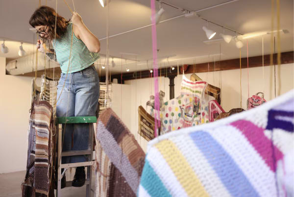 Baylee Schmitt installs a dresser in her crocheted installation at LaiSun Keane. JESSICA RINALDI/GLOBE STAFF