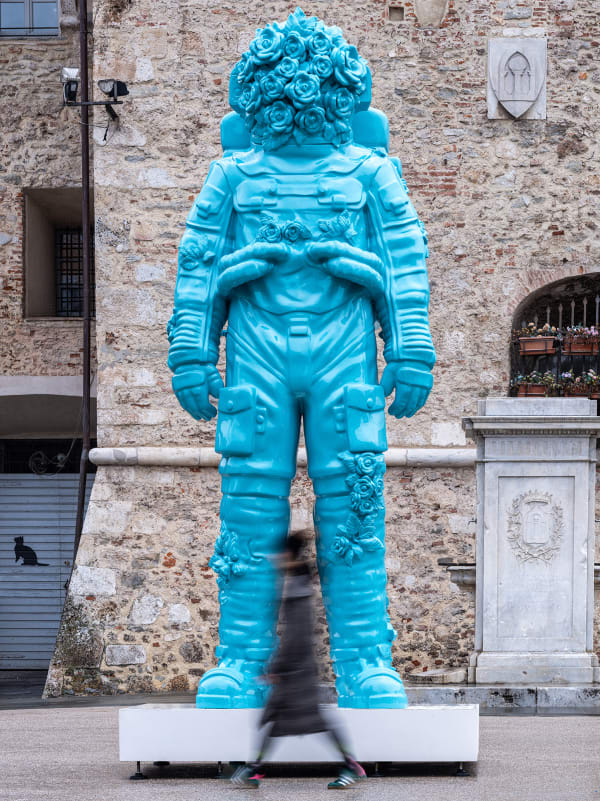 Marble sculpture featuring a spaceman his suit fill of flowers, part of the 'Spaceman' series by artist Filippo Tincolini view from the front