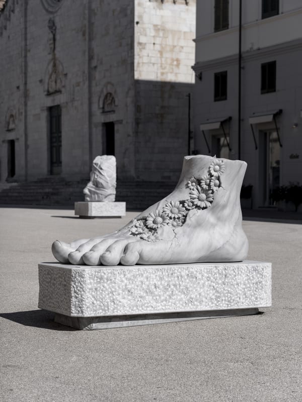 Marble sculpture featuring a spaceman his suit fill of flowers, part of the 'Spaceman' series by artist Filippo Tincolini view from the front