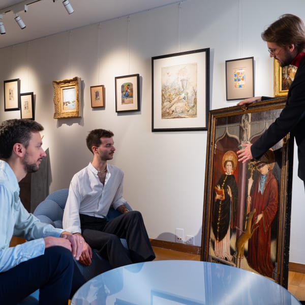 art collector in an art gallery, examinating an old master german painting from the late 15h century, with the art dealer showing them the artwork.
