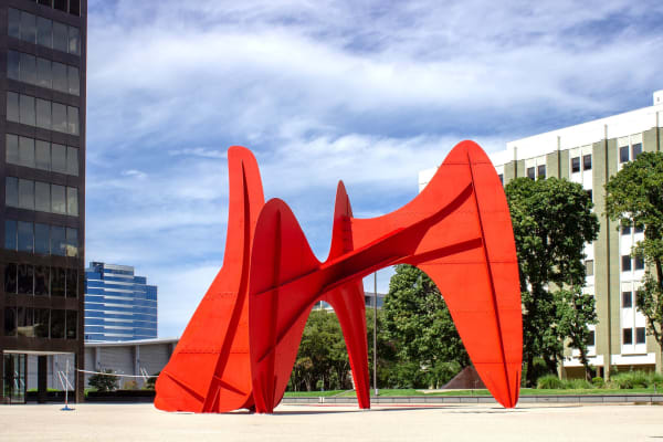 Alexander Calder sitting in front of La Grande Vitesse. 1969
