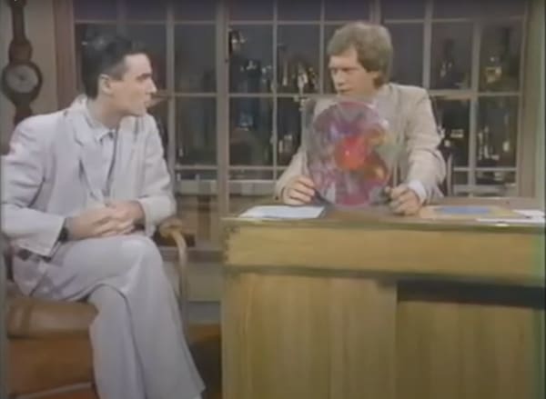 David Byrne (l) explaining Robert Rauschenberg's album design to David Letterman (r). 1983