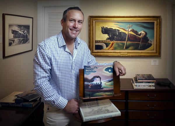 Clay Surovek of Surovek Gallery organized Thomas Hart Benton: Mechanics of Form in collaboration with Lester-Thompson Fine Art. Behind him is the show’s most prominent painting, the 1926 oil Going West. The exhibition runs through March 31. [Damon Higgins/palmbeachdailynews.com]