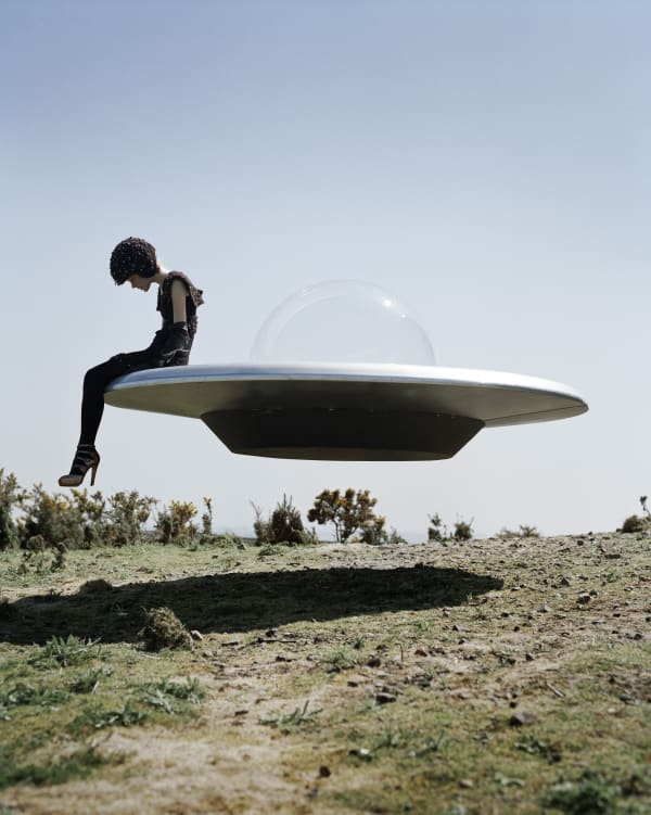Tim Walker, Kinga Rajzak on flying saucer, Eglingham Hall, Northumberland, 2009