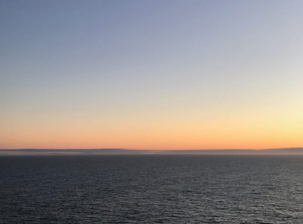 a clear sky just after sunset over the sea