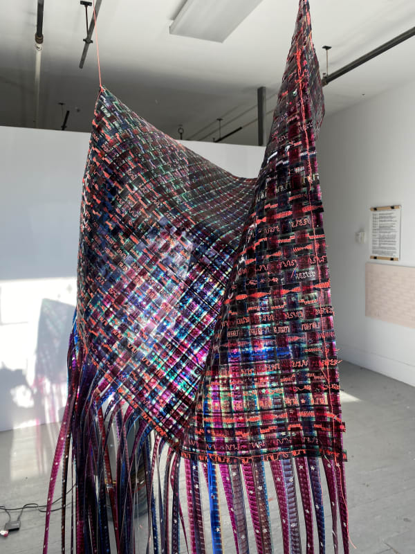 Agustina Markez Desde Lejos Weaving, 2021 16mm film strips, decorative stitches with red thread 36 x 24 in.