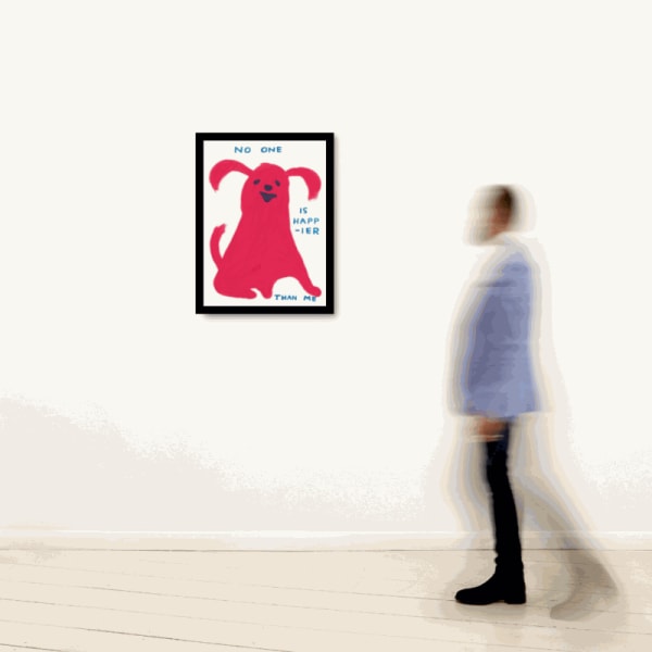 Person walking past a framed artwork by David Shrigley on a white wall.