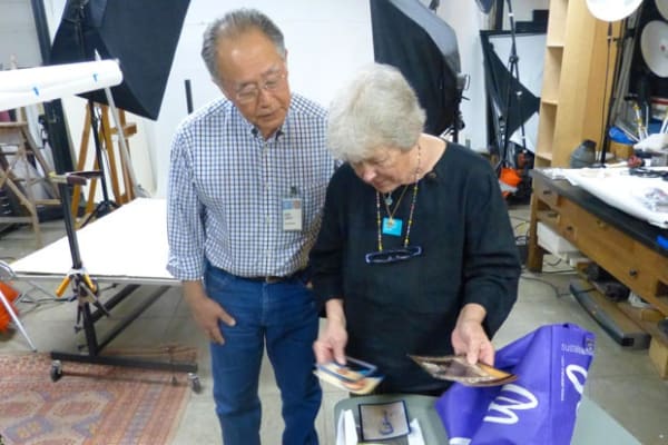 Walden Morton showing museum photographer Shuzo Uemoto images of her extended family, including Lionel Walden’s wilderness-loving brother, Arthur, who was...