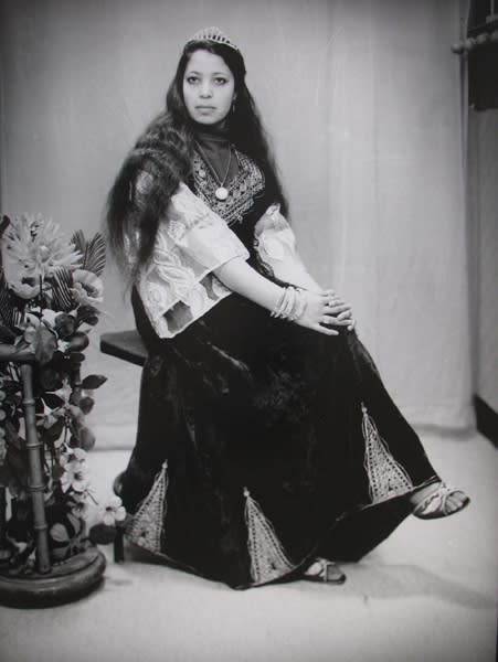 Black and white photograph of a woman in a portrait studio