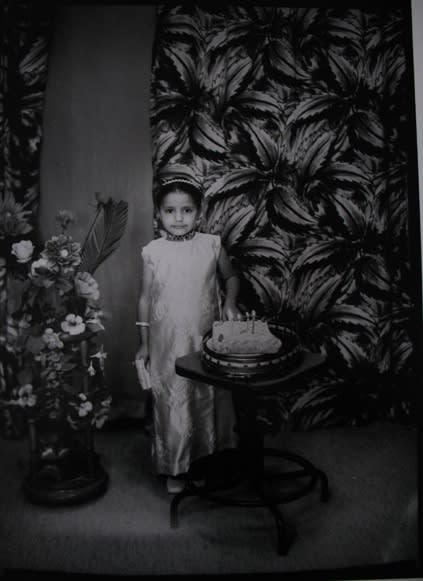Black and white photograph of a woman in a portrait studio