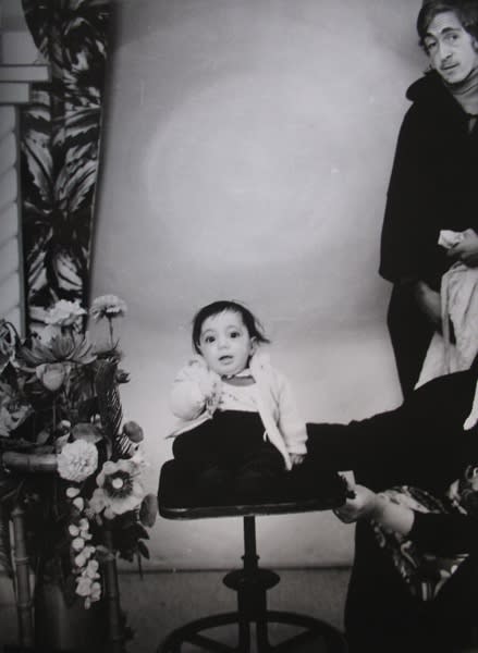 Black and white photograph of a baby in a portrait studio