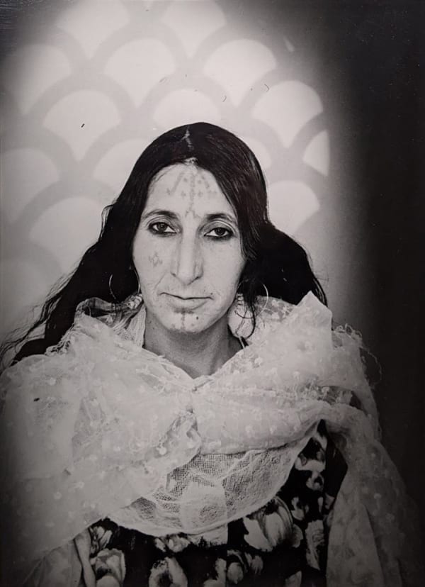 Black and white photograph of a woman in a portrait studio