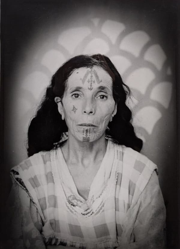 Black and white photograph of a woman in a portrait studio