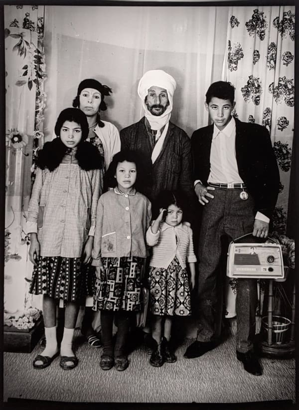 Black and white photograph of a family in a portrait studio