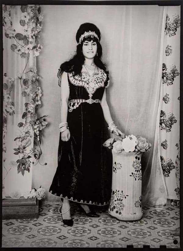 Black and white photograph of a woman in a portrait studio