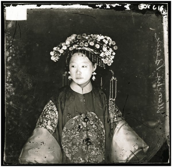 Black and white photograph of Machu Bride posing in traditional clothing in Peking