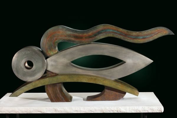 Silver, green, and multicolored sculpture on white surface
