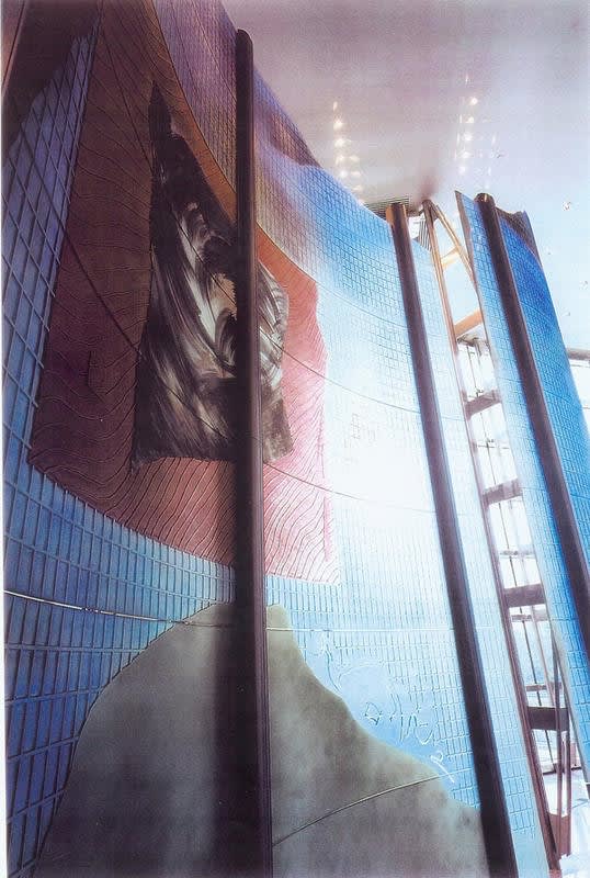 Large dichroic glass sculpture like an oversize modular screen (green, yellow, blue)