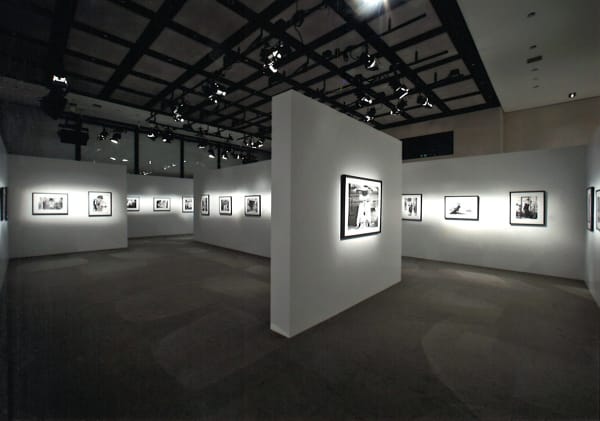 Installation view of the exhibition Coco Chanel, 1962: Photographs by Douglas Kirkland featuring several black and white photographs of Coco Chanel in Ginza, Tokyo
