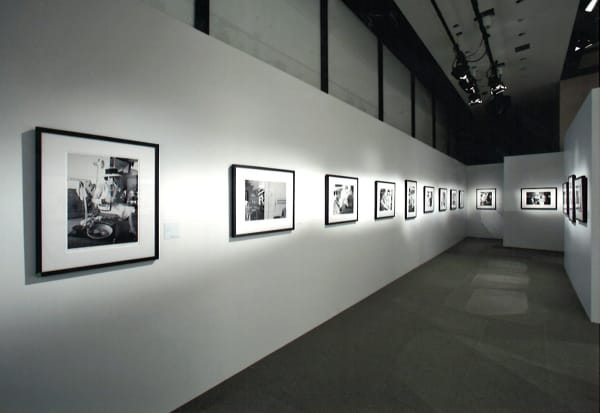 Installation view of the exhibition Coco Chanel, 1962: Photographs by Douglas Kirkland featuring several black and white photographs of Coco Chanel in Ginza, Tokyo