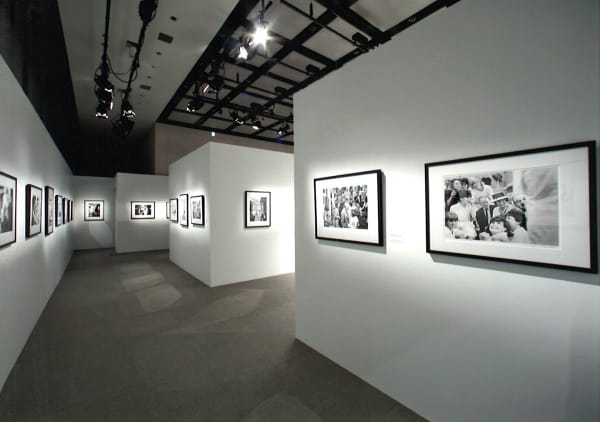Installation view of the exhibition Coco Chanel, 1962: Photographs by Douglas Kirkland featuring several black and white photographs of Coco Chanel in Ginza, Tokyo