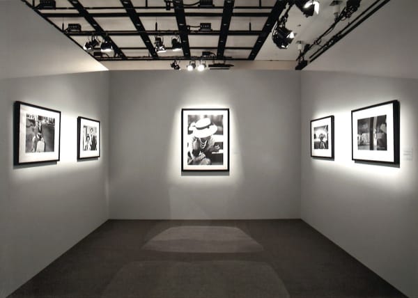Installation view of threes wall of the exhibition Coco Chanel, 1962: Photographs by Douglas Kirkland featuring several black and white photographs of Coco Chanel in Ginza, Tokyo