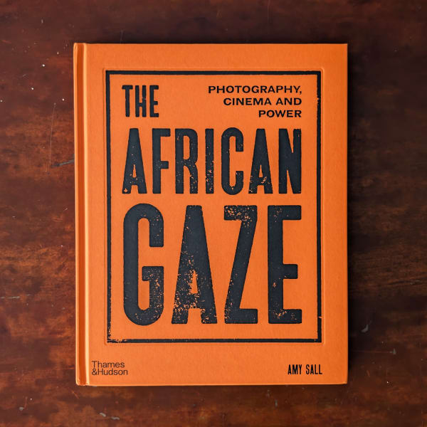 Photograph of an orange book cover featuring the title 'The African Gaze'