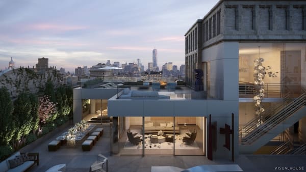 Outdoor view of a staged outdoor terrace with recessed lighting and luxury furniture, under the backdrop of the New York City skyline at sunset.