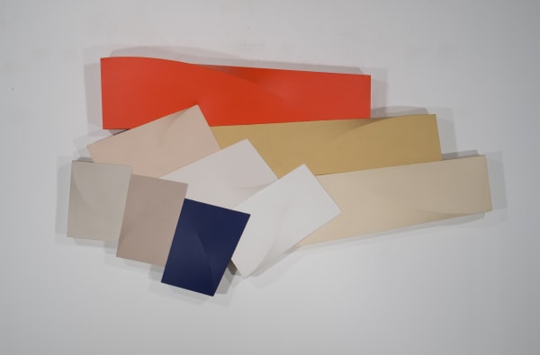 tri-dimensional painting in warm hues and white mounted on a wall