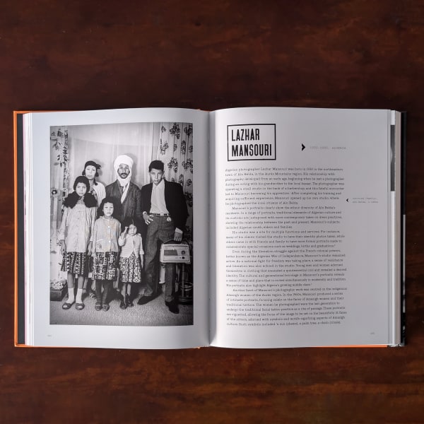Photograph of pages in an open book featuring black and white portrait photographs by photographer Lazhar Mansouri
