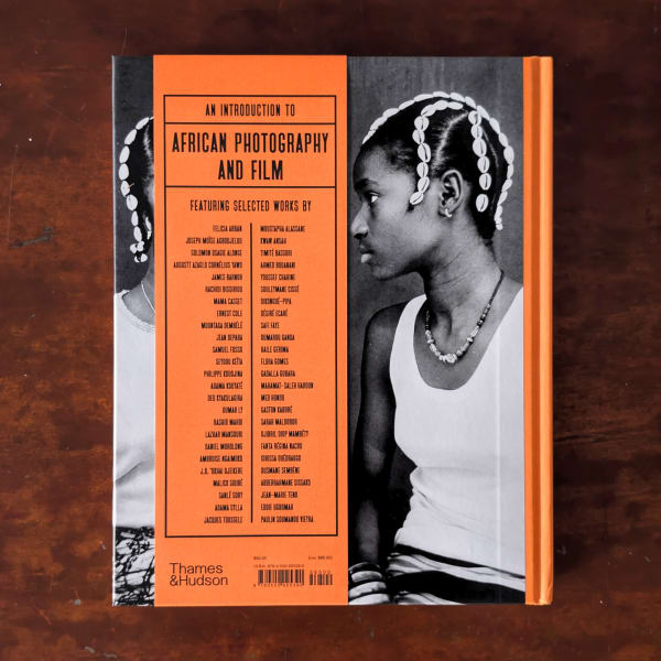 Photograph of the back cover of a book featuring a black and white portrait photograph and a list of photographers including Lazhar Mansouri