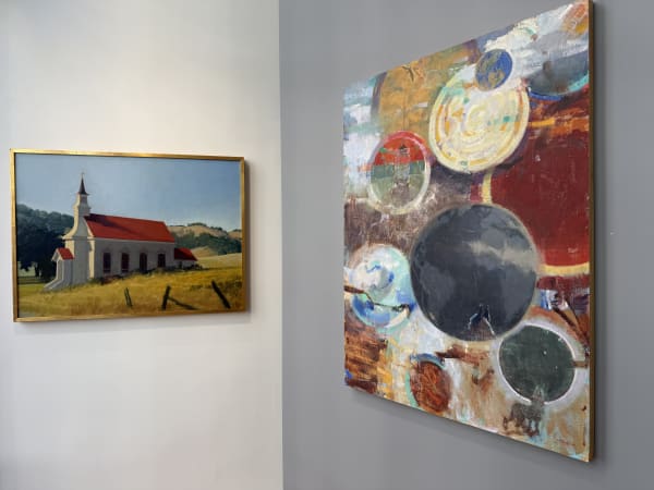 a gallery wall showing paintings by Randall Sexton