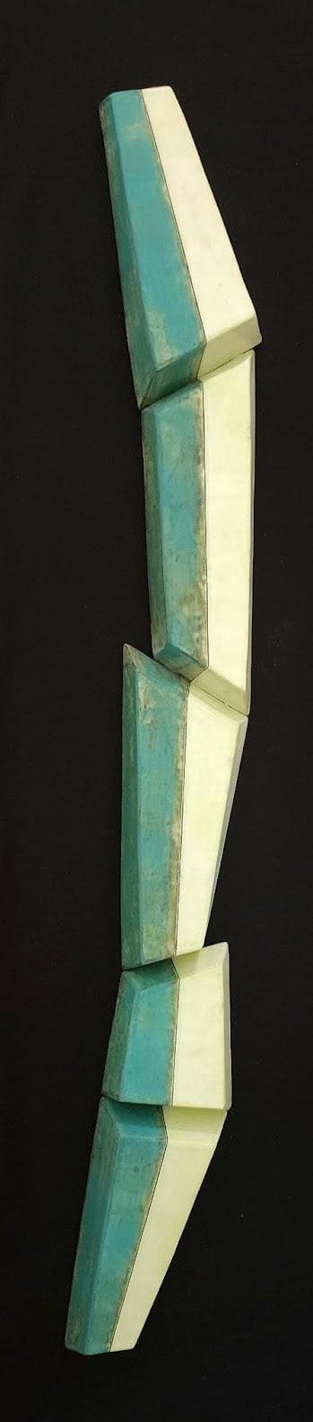 a long thin glazed ceramic wall scullpture