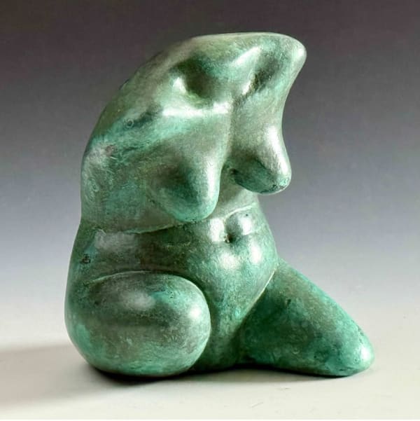 a bronze sculpture of a woman's torso